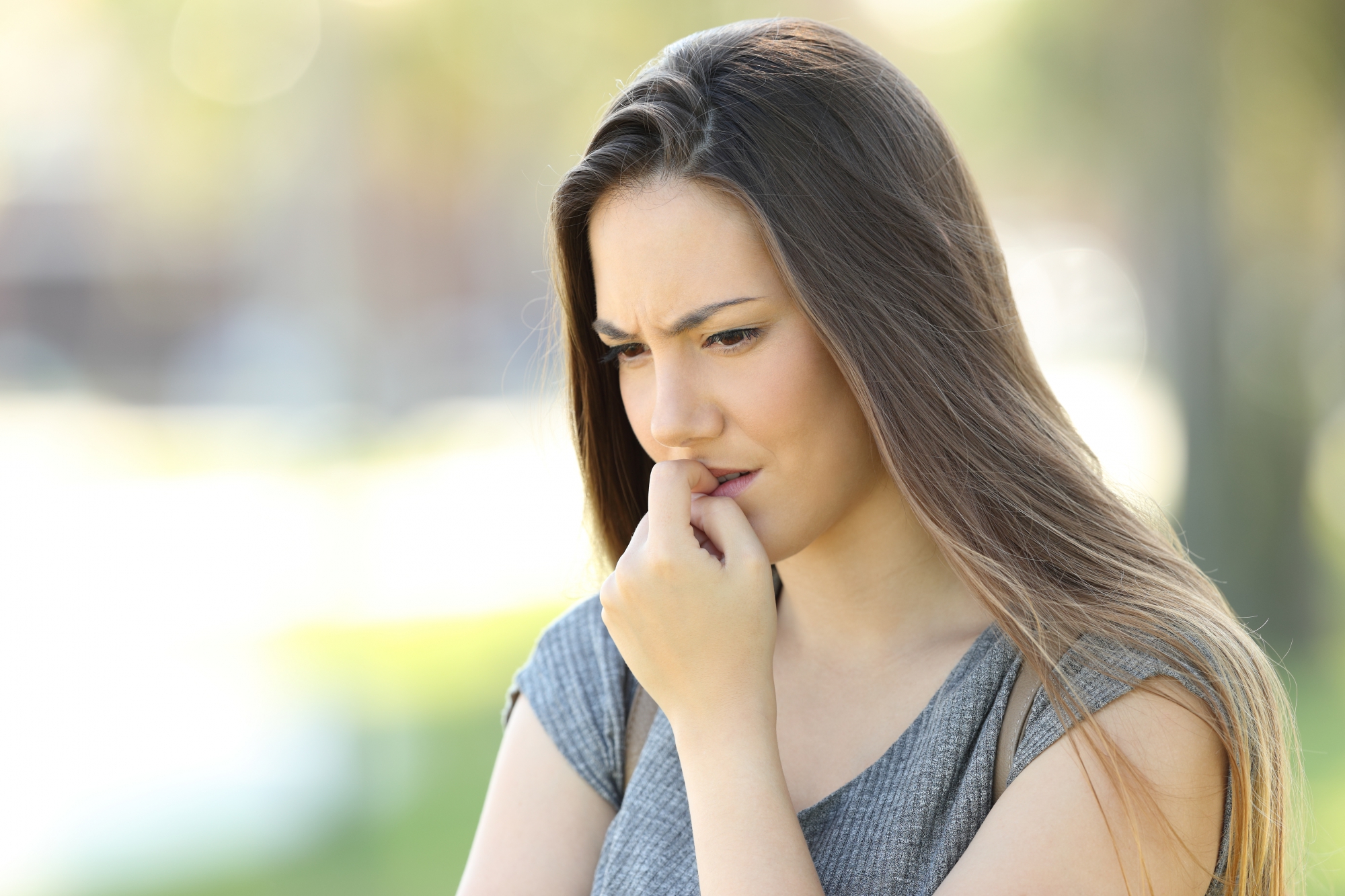 anxious woman biting nails
